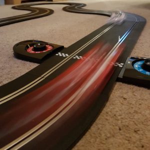 Cars speeding by on the Scalextric track