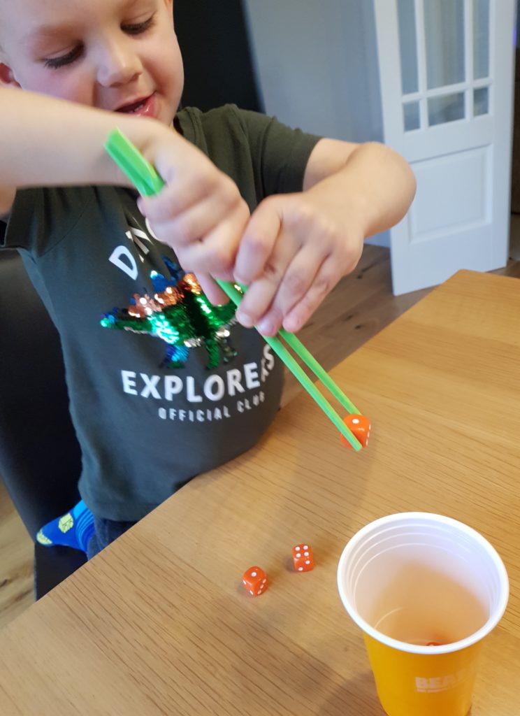 Joshua trying the chopsticks challenge