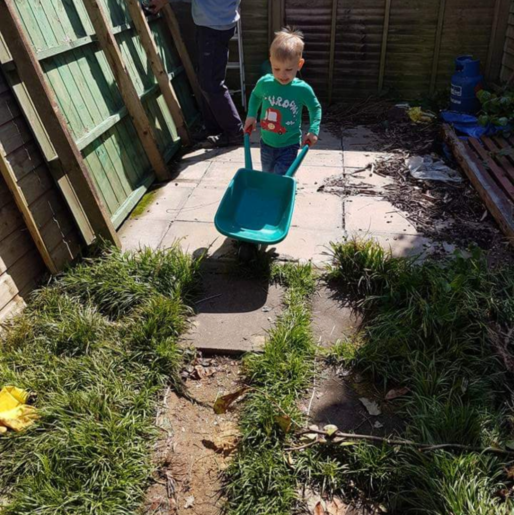 Joshua pushing wheelbarrow